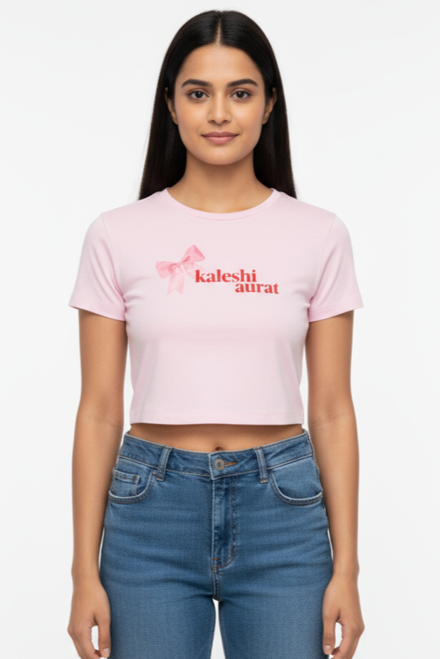 Woman wearing a pink t-shirt with text and blue jeans on a white background