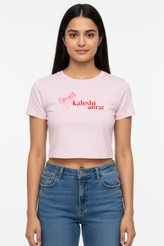 Woman wearing a pink t-shirt with text and blue jeans on a white background